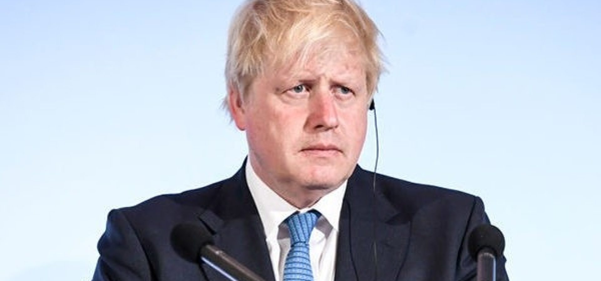 Wibest – British Prime Minister: Boris Johnson standing behind a podium.