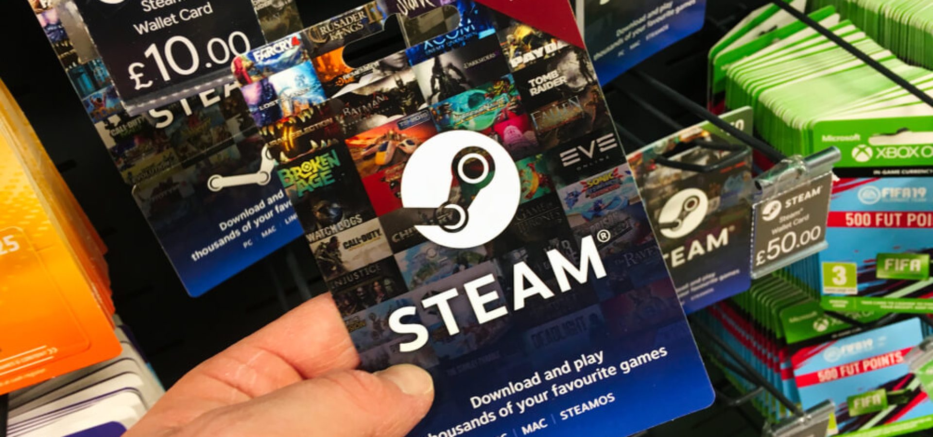 Gift card voucher for steam wallet money credit on a shelf in a shop.