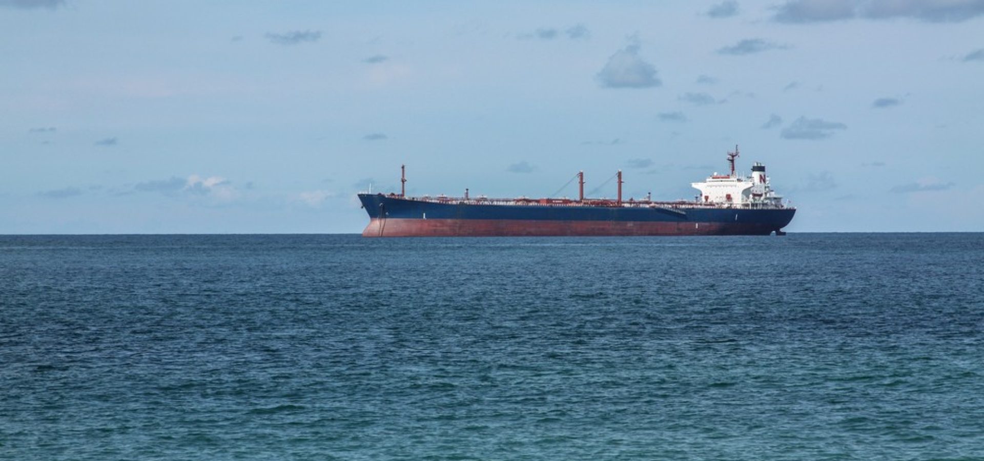Wibest – Tanker Ship: A tanker ship in the middle of the sea.
