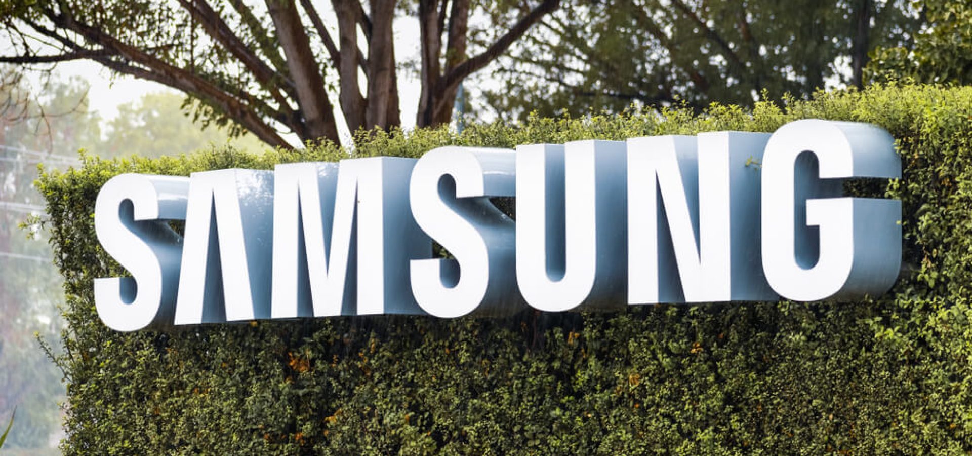 Samsung Sign displayed in front of the modern headquarters of Samsung Electronics Device Solutions.