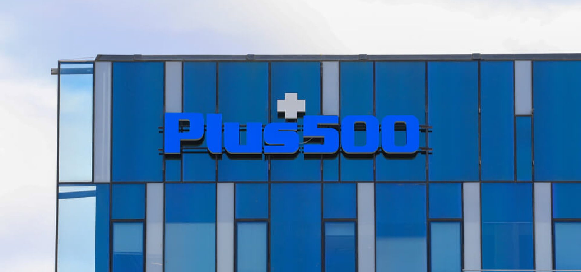 Plus500 logo sign on the office building.