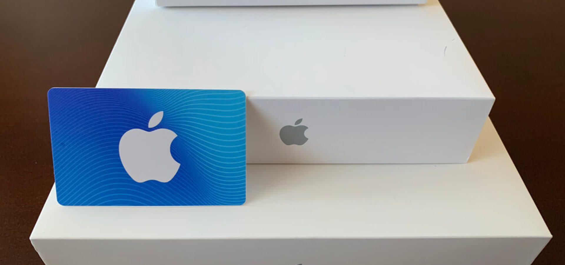 Apple product boxes with an Apple gift card