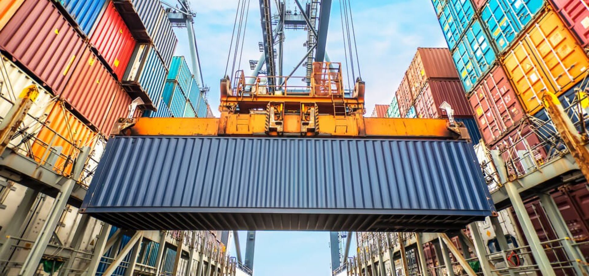 Wibest Broker — Shipping: Container loading in a Cargo freight ship wit industrial crane.