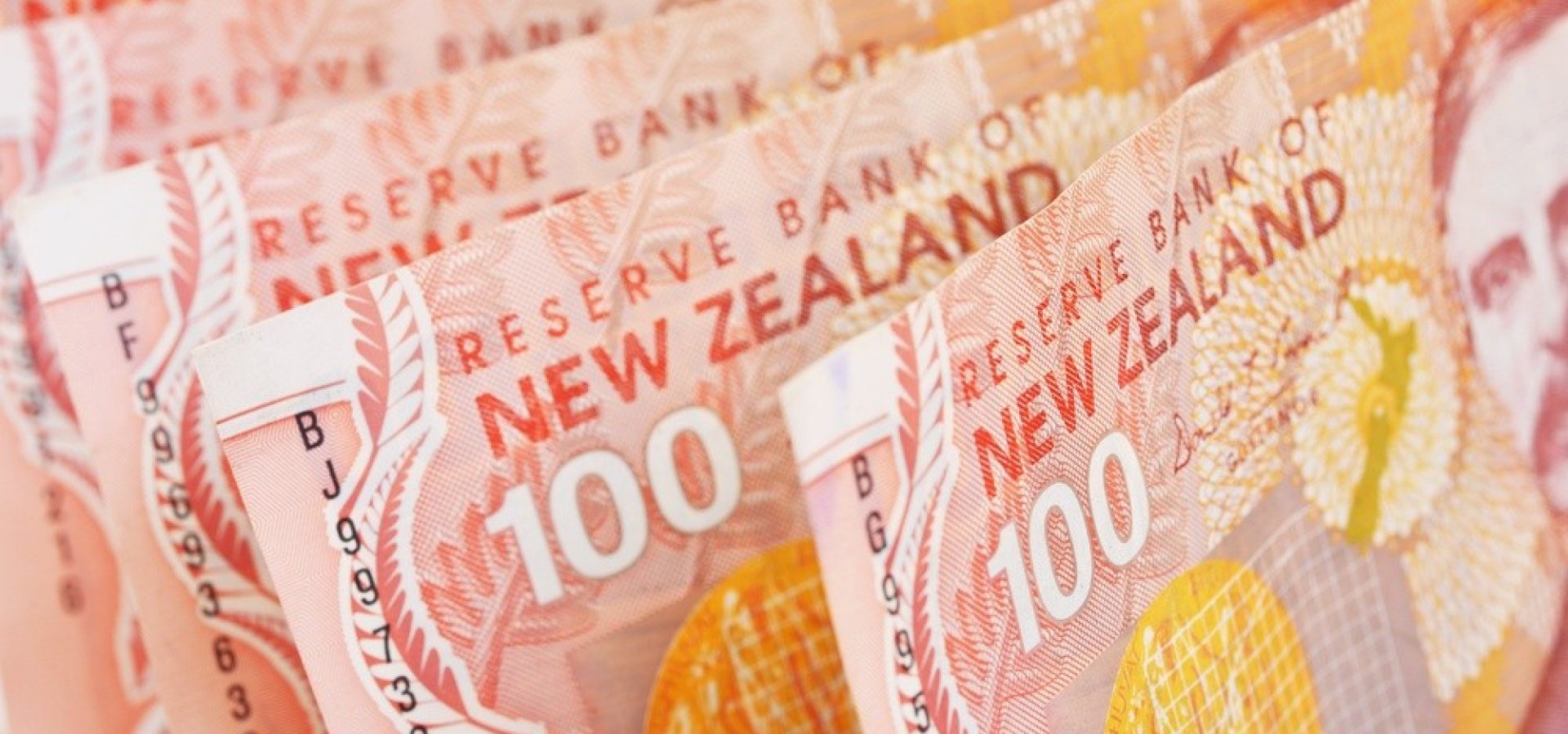 Wibest – NZD/USD: One hundred New Zealand dollar bills.
