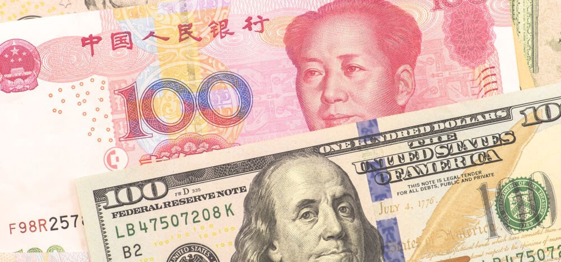 Forex Markets: Yuan and Dollar banknotes.