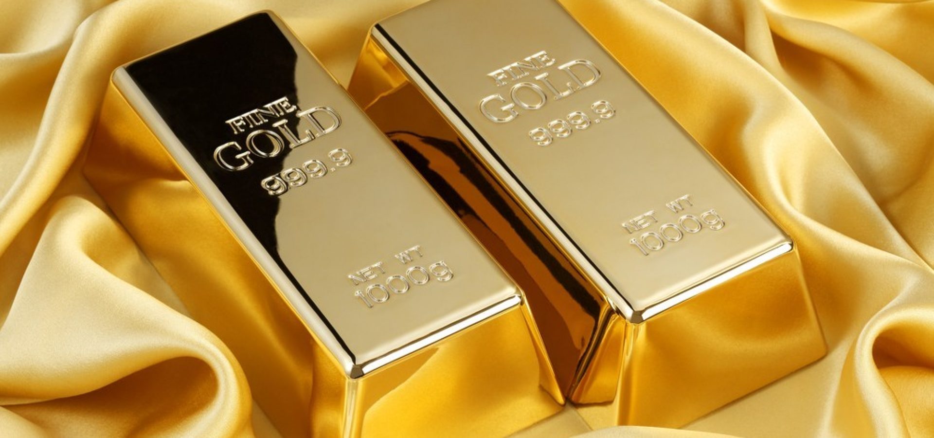 Wibest – Spot Gold Prices: Two gold bars over a gold clothe.