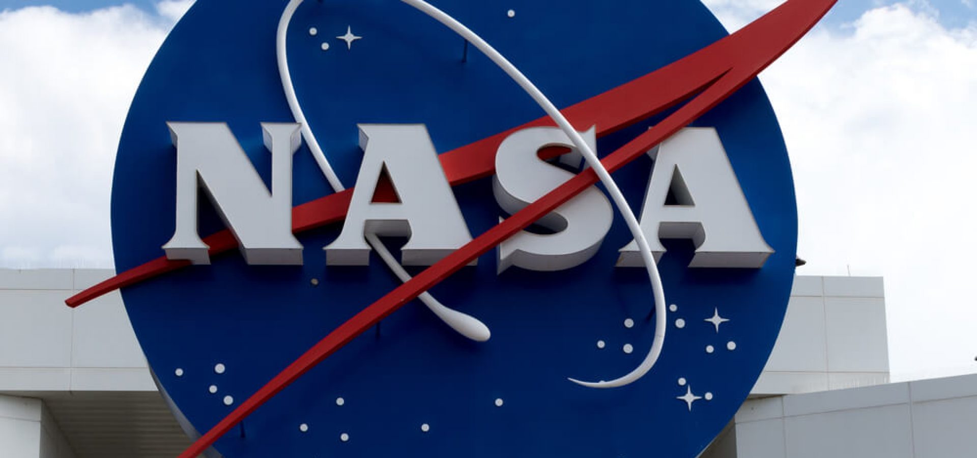 NASA logo with blue cloudy sky background