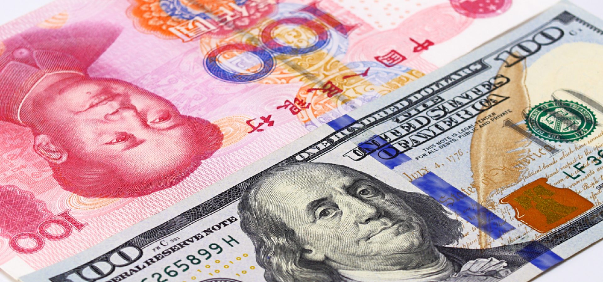 Wibest – USD to Chinese Yuan: Chinese yuan and US dollar bills.