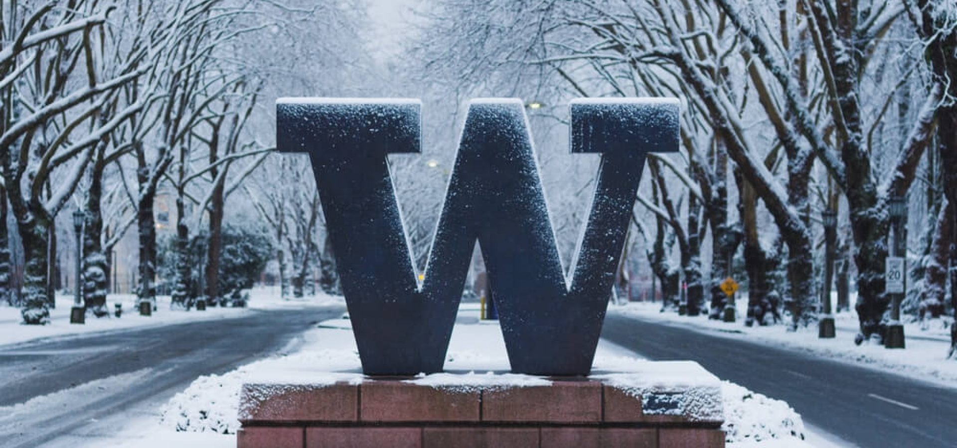 University of Washington welcome sign under snow.