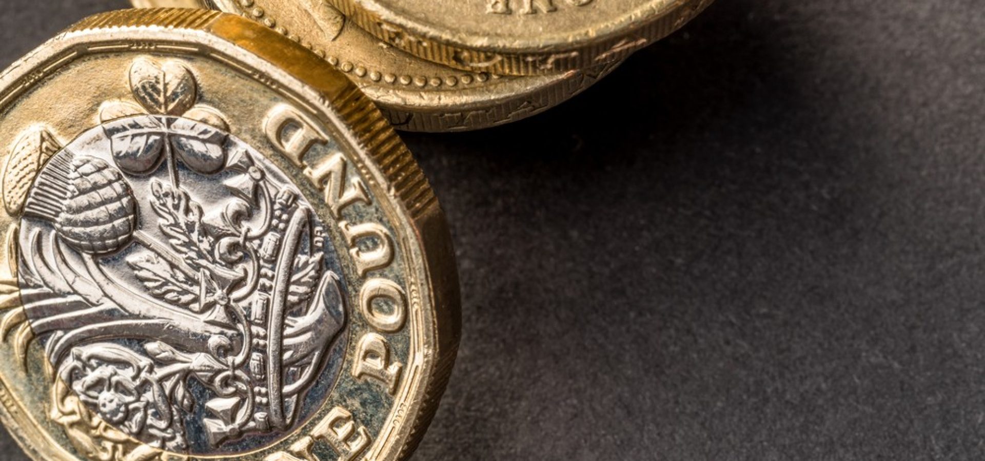 Wibest – USD GBP: A stack of British pound sterling coins.