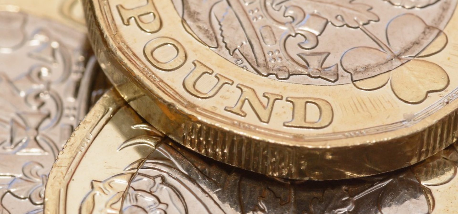 Wibest – USD GBP: A close up of a British pound coin.