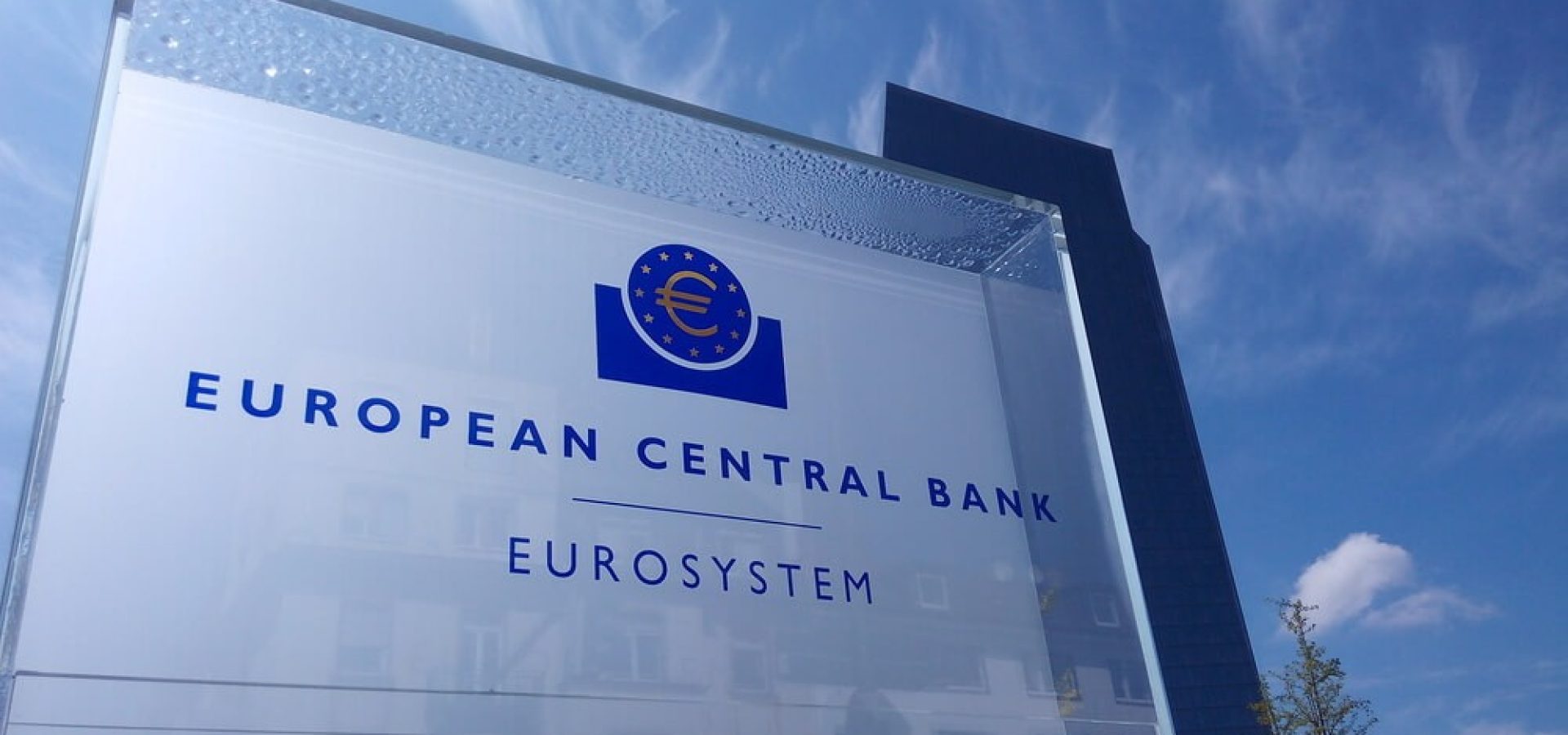 Sign of the European Central Bank with the headquarters in the background.