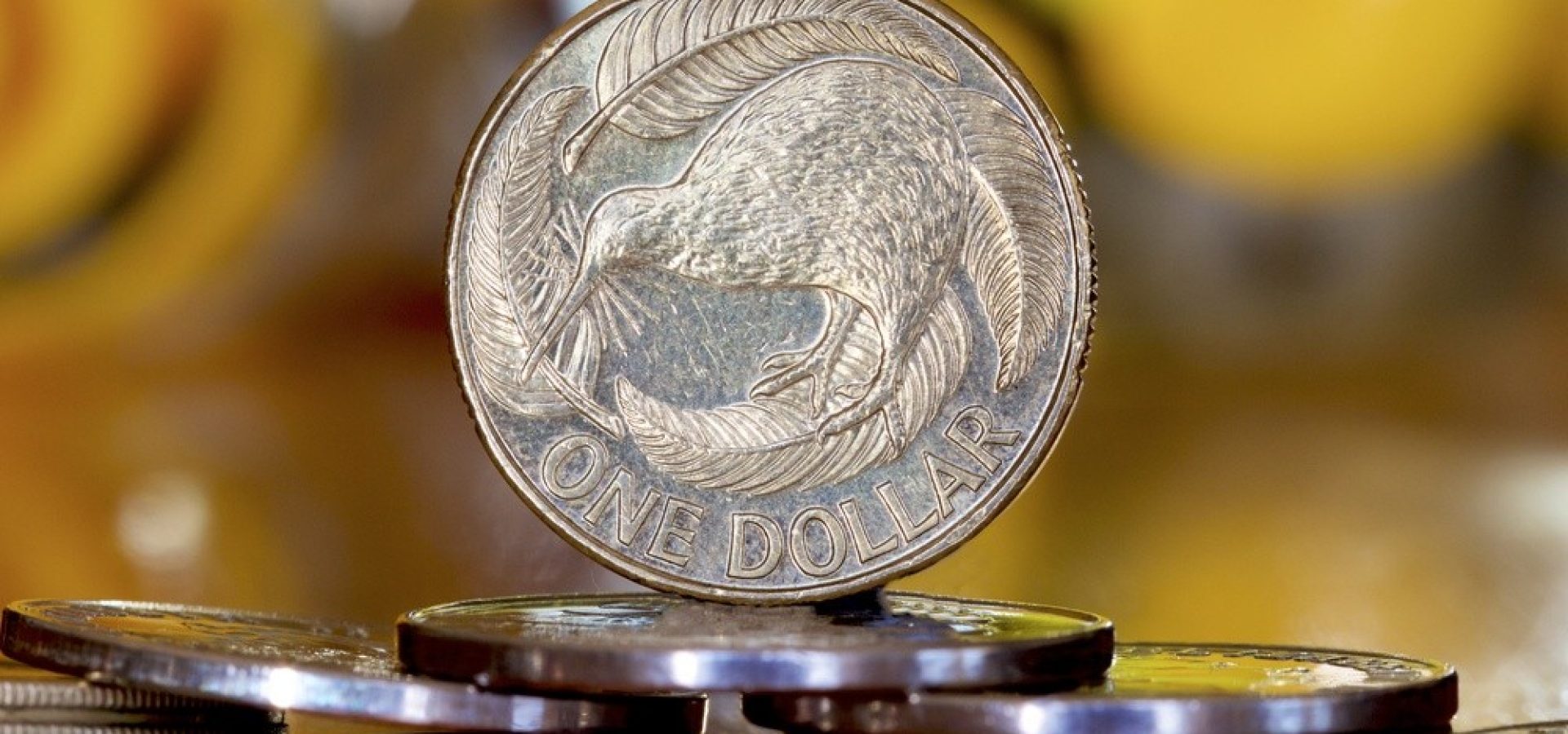 Wibest – NZD USD: A close up of a New Zealand dollar coin.