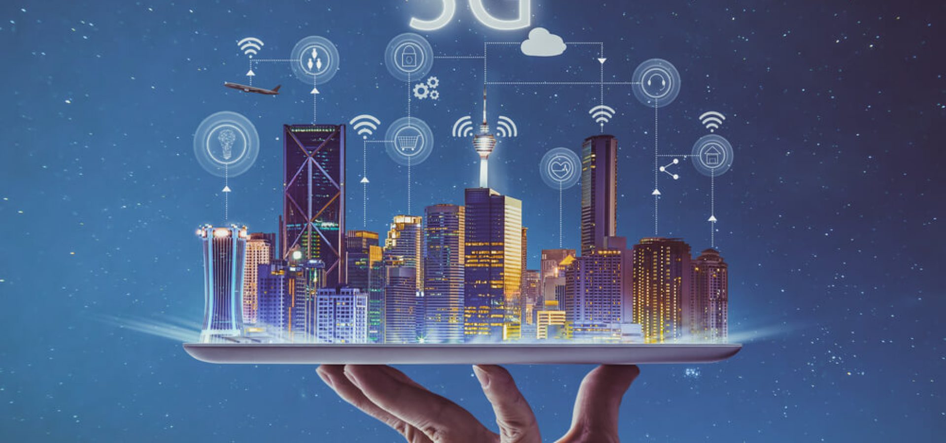 America: hand holding an empty digital tablet with smart city and 5G network wireless systems and internet of things.
