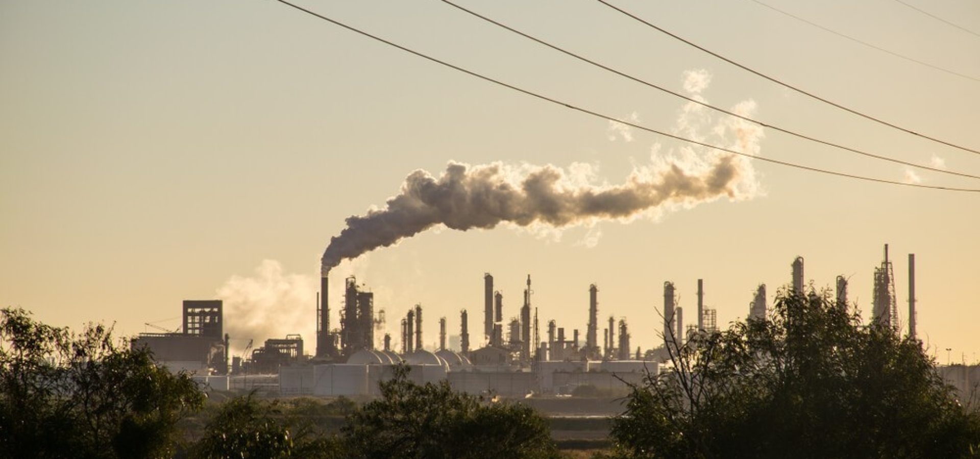 Climate Change: Oil refineries polluting carbon and cancer causing smoke stacks climate change.