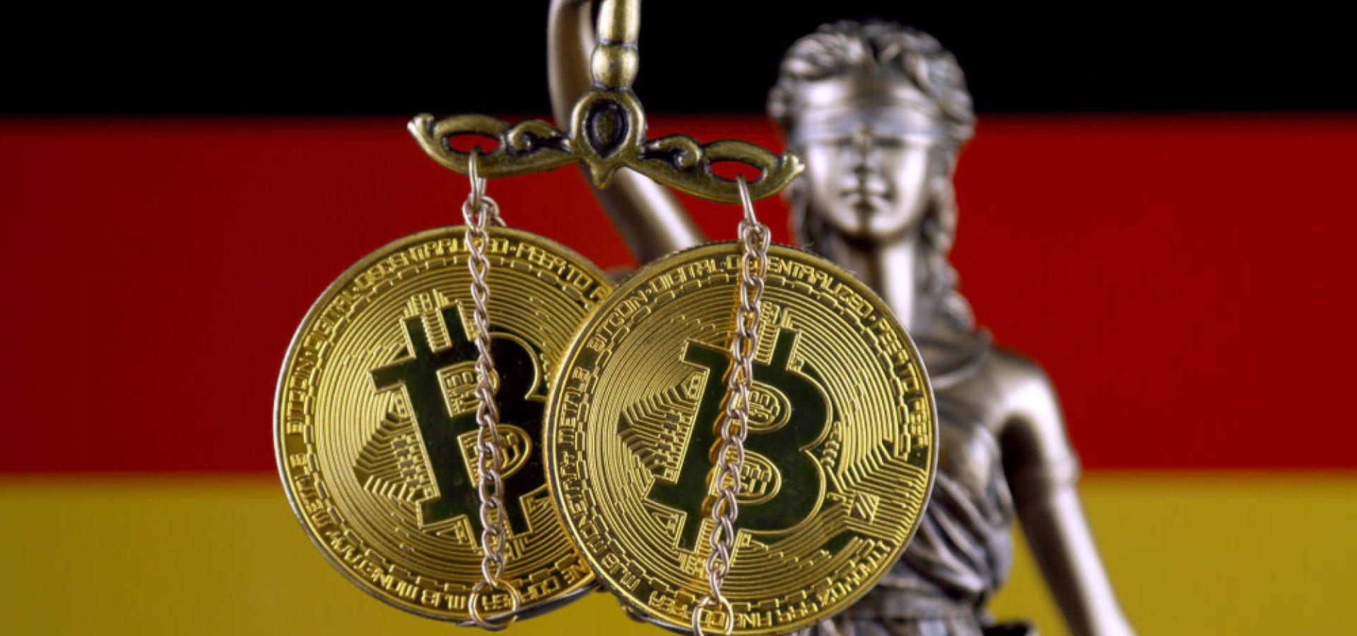 German: Symbol of law and justice, physical version of Bitcoin and Germany Flag.
