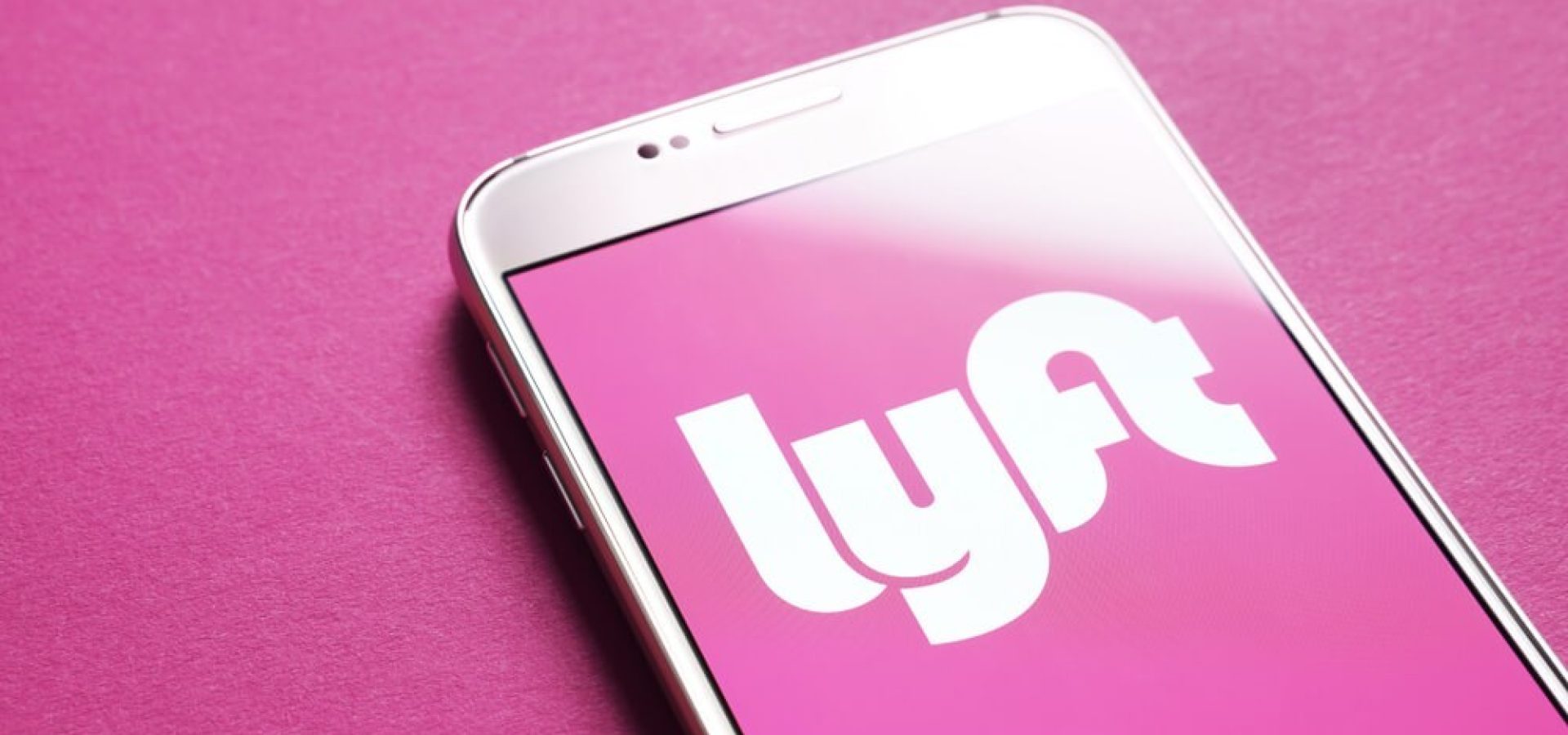 Lyft drivers: Lyft logo on smartphone screen.