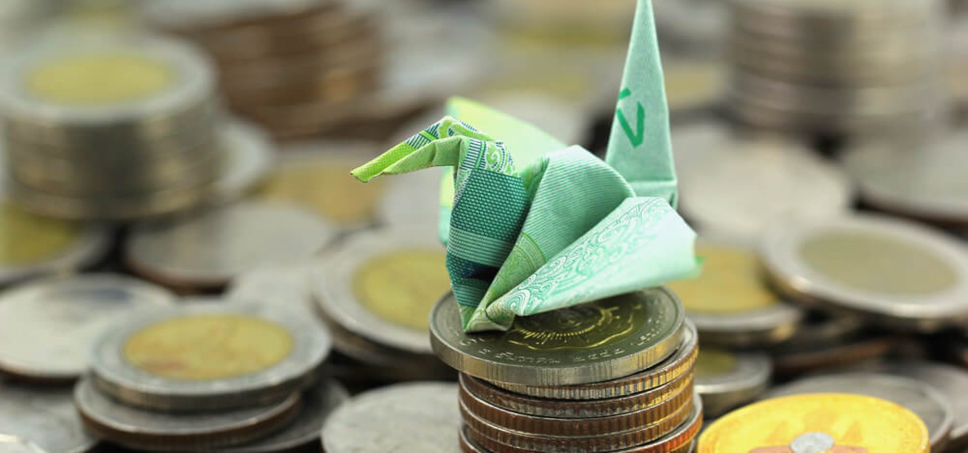 paper origami on top of coins concept exchange rates