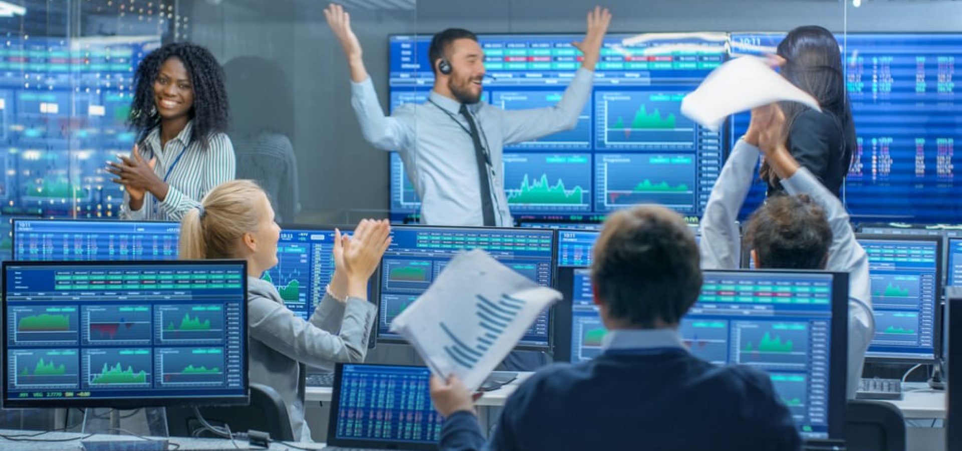 day traders in front of computers and terminals for trading